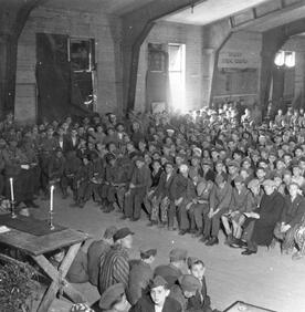 Rabbi Herschel Schacter conducting services at the liberated Buchenwald concentration camp in 1945.